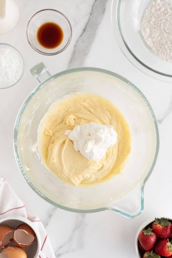 A dollop of sour cream added to the batter in the glass bowl