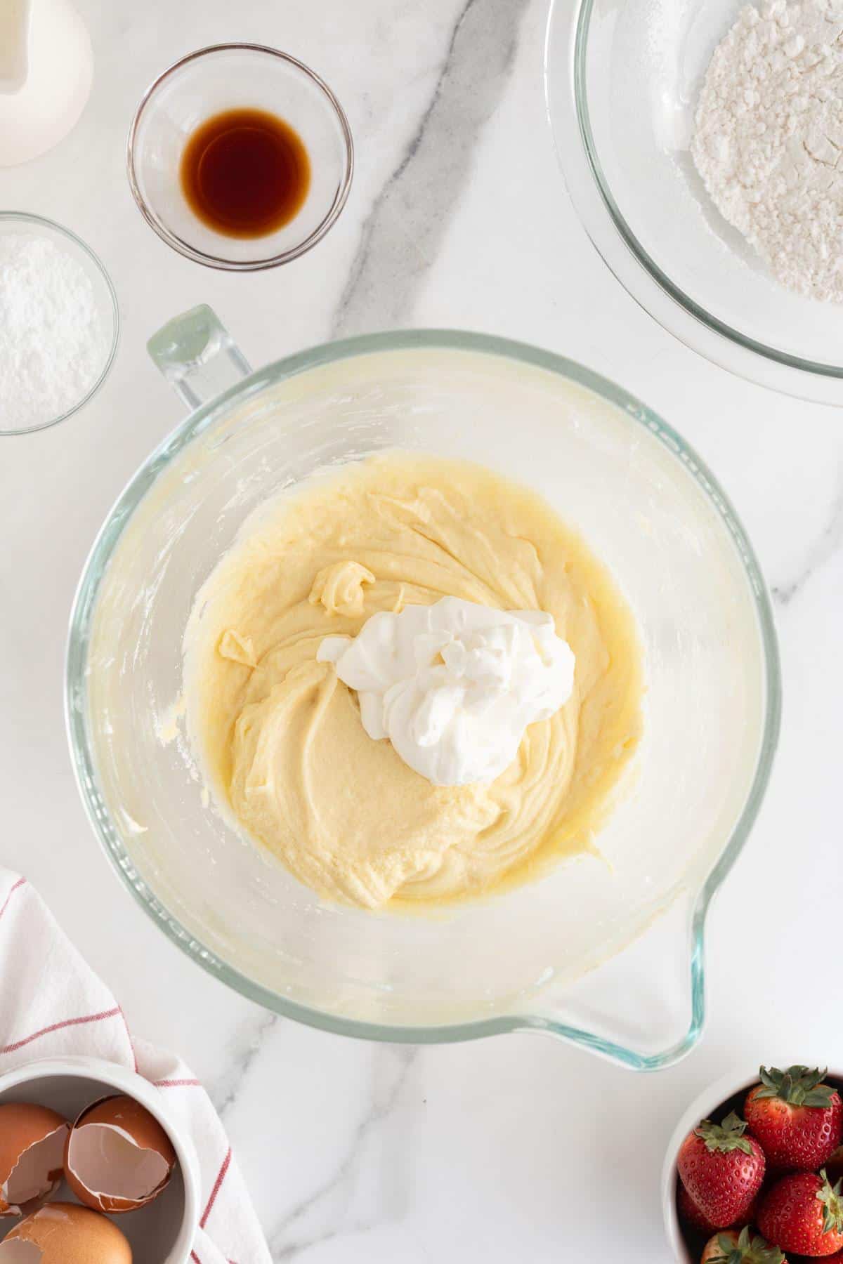 A dollop of sour cream added to the batter in the glass bowl