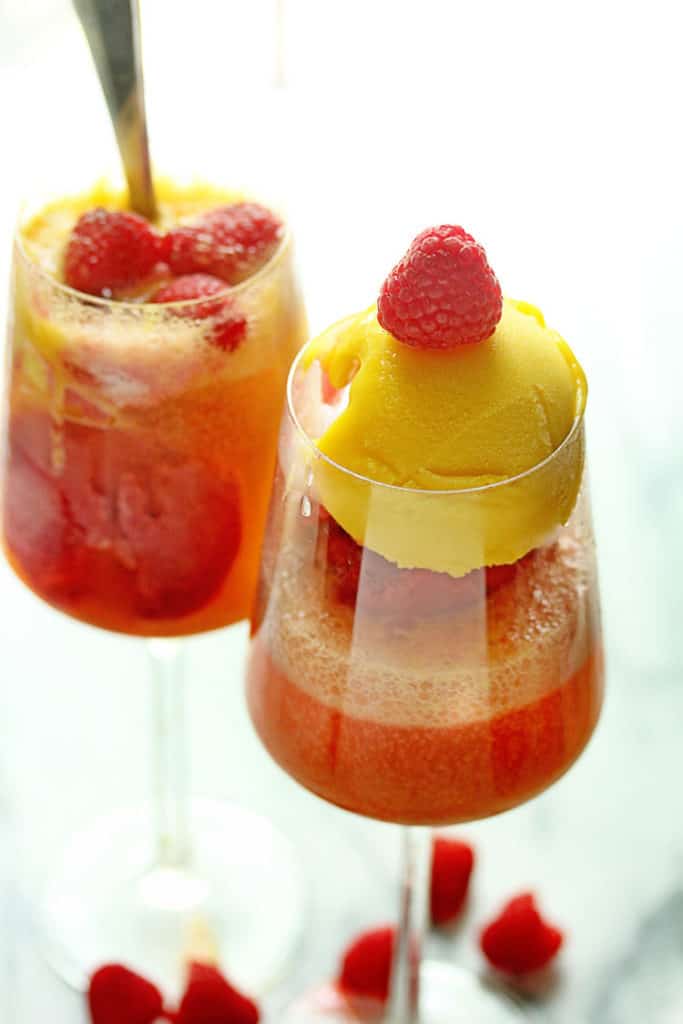Two summer sorbet floats served in wine glasses