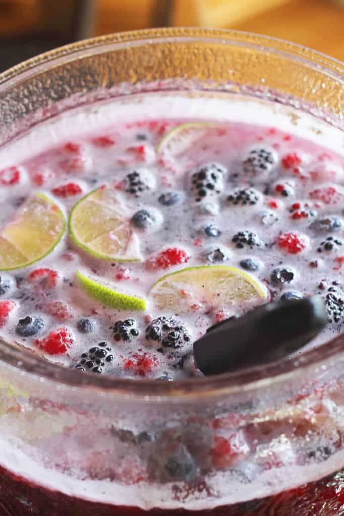 A close up of a punch bowl full of blackberry punch