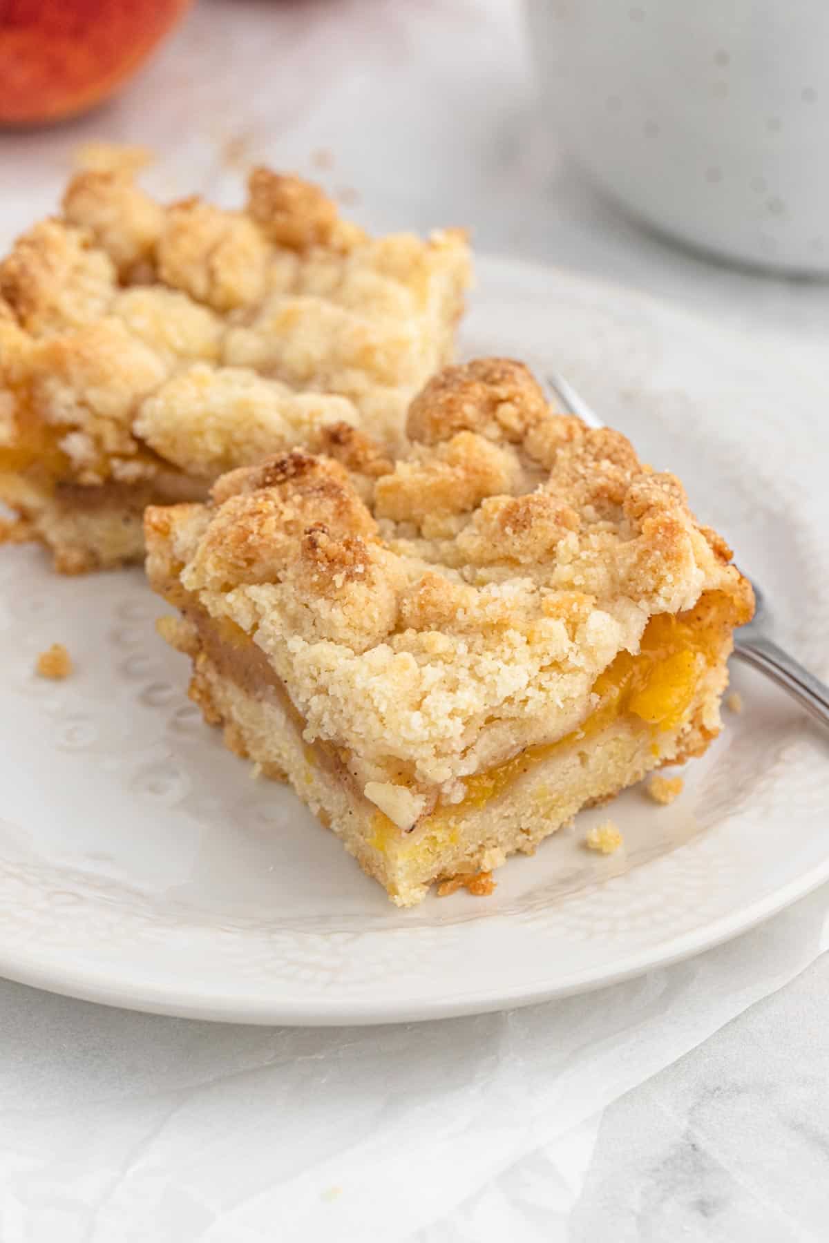 Peach Crumb Bars on a white plate