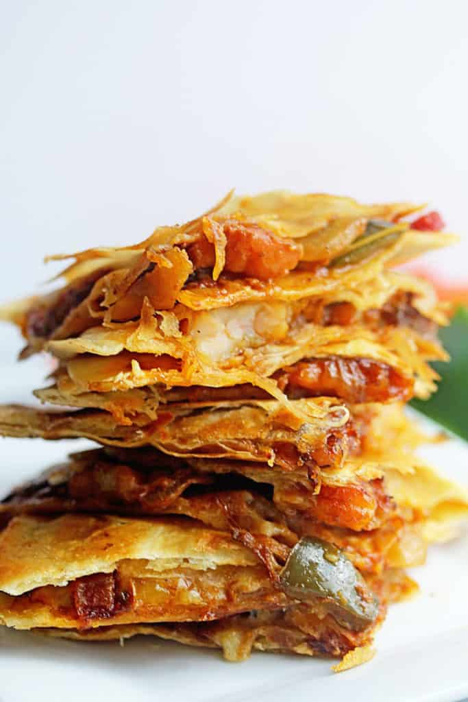 Close up of a stack of Shrimp Fajitas Quesadillas served on a white plate