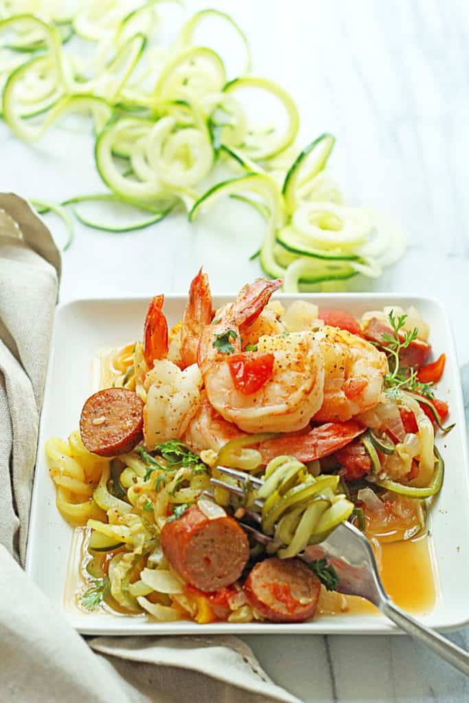 Cajun Shrimp Zoodles served on a square, white plate with a fork