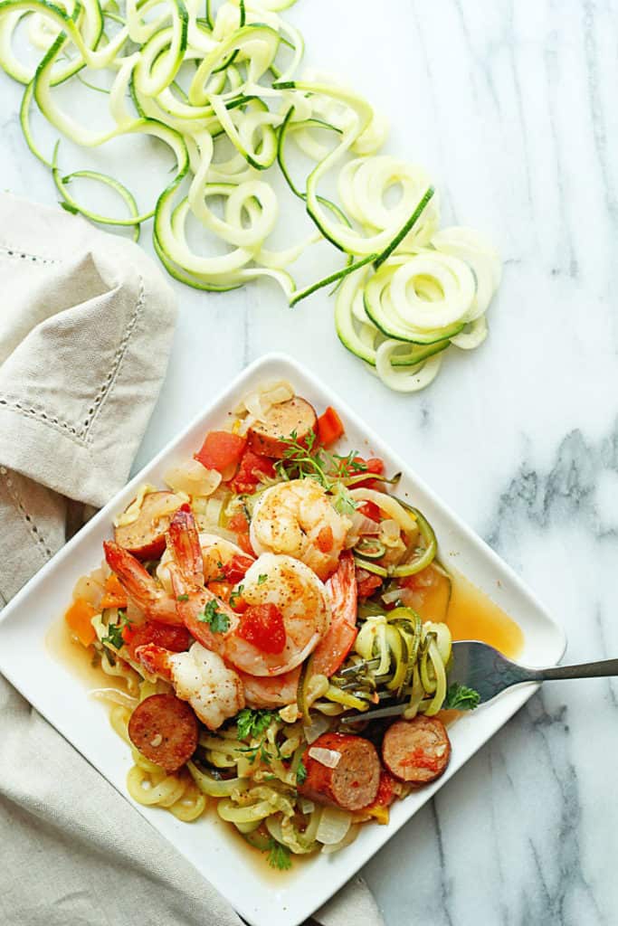 Overhead shot of Cajun Shrimp Zoodles served on a square, white plate with a fork