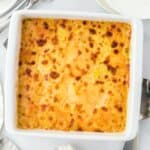 Overhead view of a golden-brown baked potato and squash gratin in a white baking dish