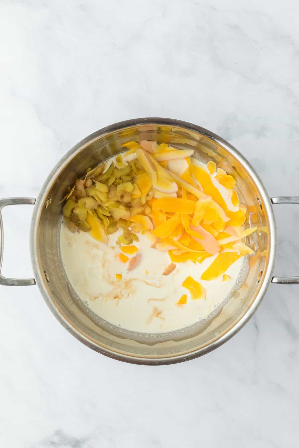 A pot with squash and potato peels simmering in cream