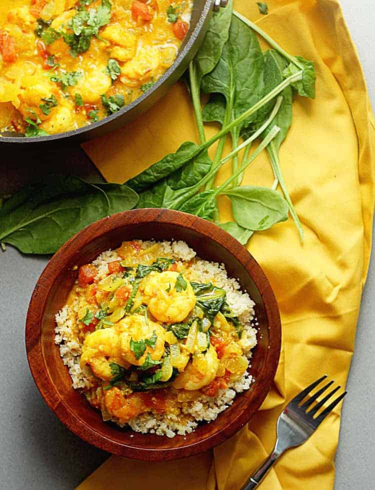 Overhead shot of Light Curry Shrimp served in a wooden bowl with the entire dish next to it