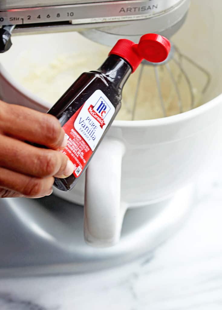 McCormick Vanilla Extract about to be poured into the batter that makes this delicious carrot cake pound cake.