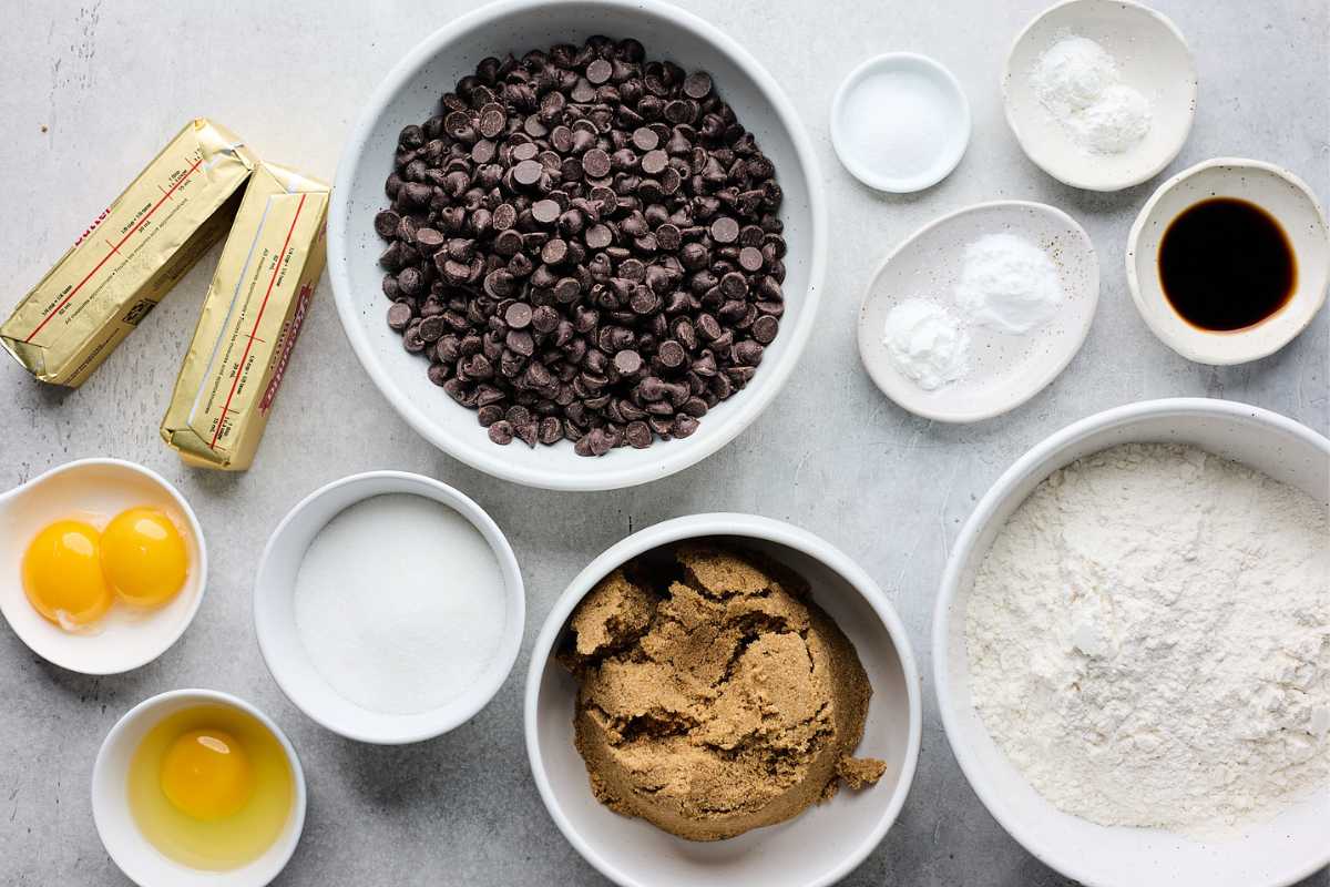 Ingredients to make chewy chocolate chip cookies on the table.