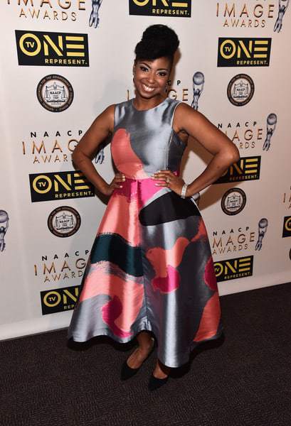 Jocelyn Delk Adams posing for a photo on the 2016 NAACP Image Awards red carpet