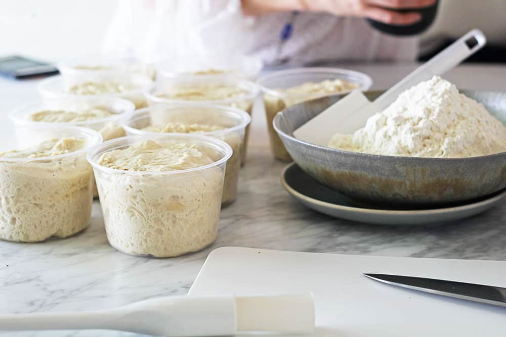 Pizza dough in plastic containers 