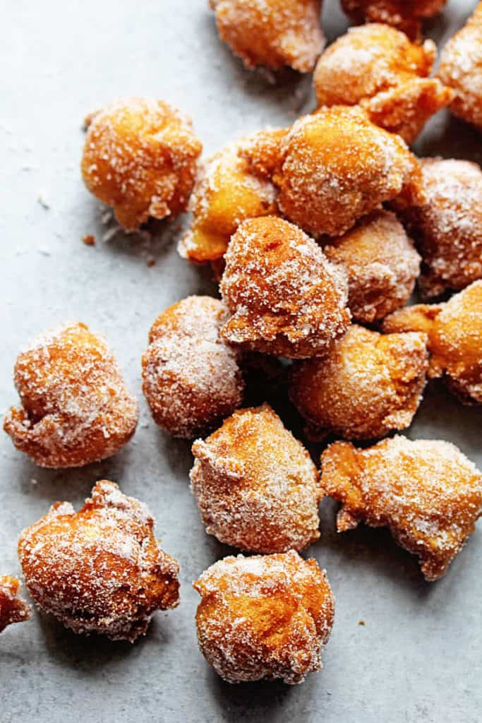 Close up of several Castagnole (Italian Fried Dough Balls with Sugar) covered in sugar