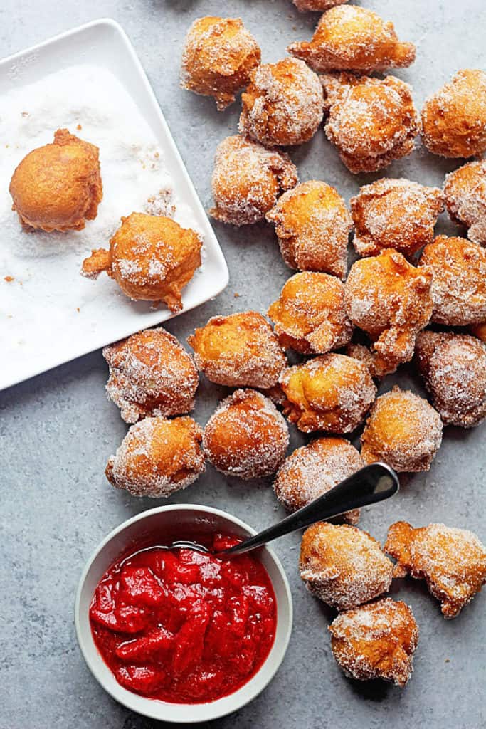 Several Castagnole (Italian Fried Dough Balls with Sugar) covered in sugar