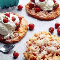 Strawberry Shortcake Funnel Cakes: Classic summer fair funnel cakes get a fun seasonal twist with a strawberry shortcake flavor! And watch the how to video!