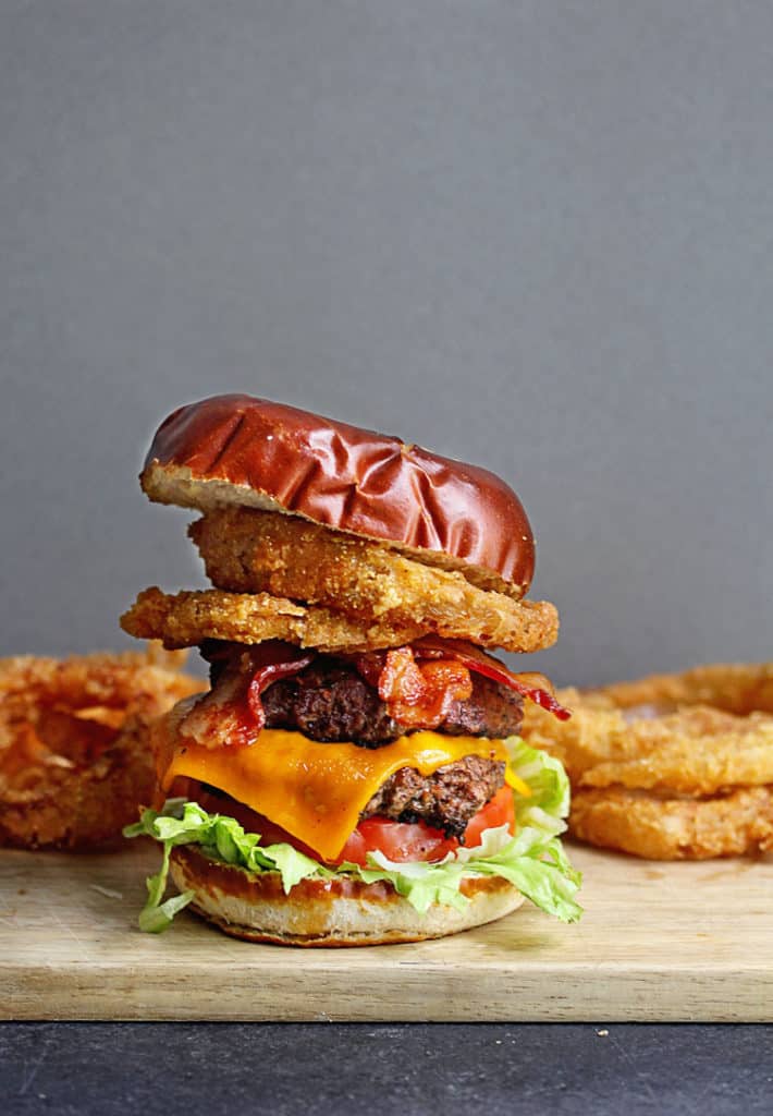 A delicious bacon cheddar burger stacked with fried onion rings