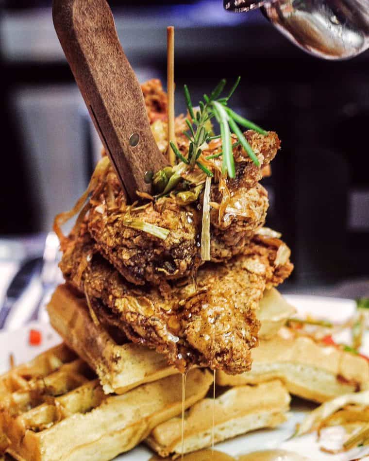 Hash House a Go Go Chicken and Waffles dish covered in syrup 