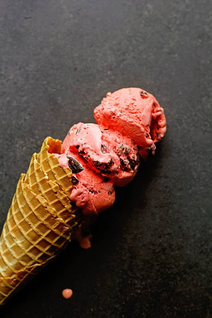 Oreo Red Velvet Ice Cream in a waffle cone. 