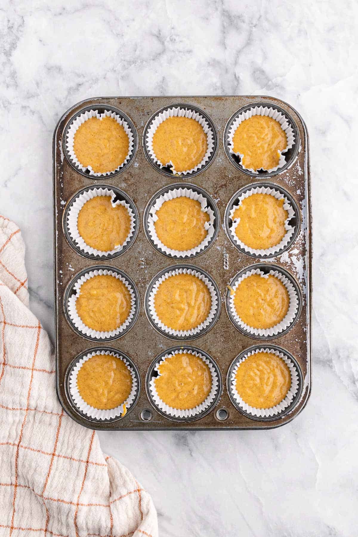 Pumpkin cupcake batter in the cupcake pan.