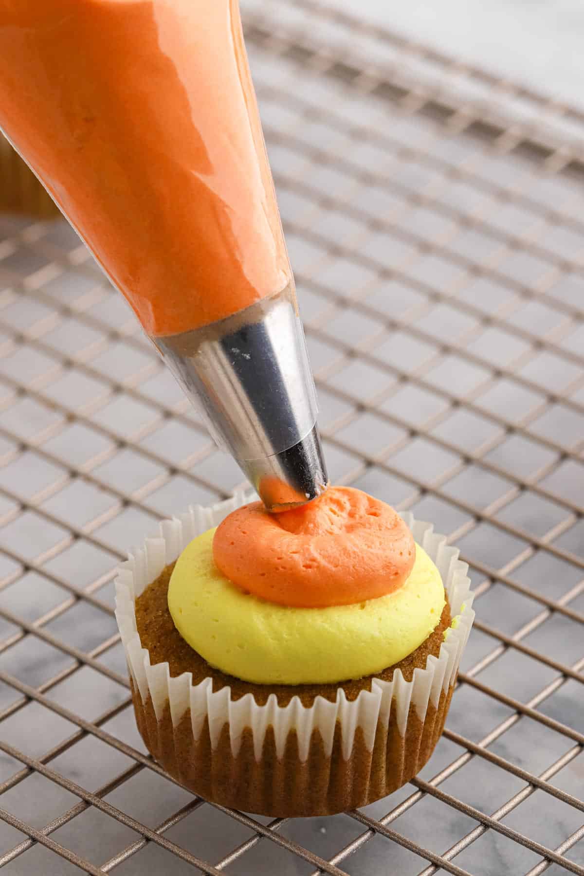 Adding the orange frosting on top.