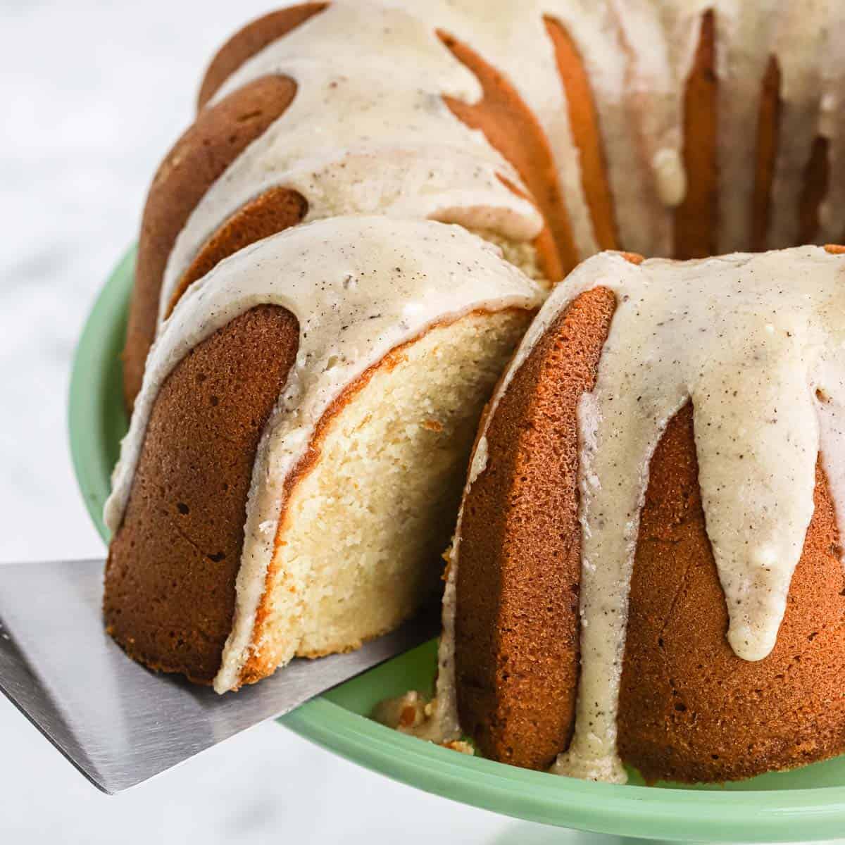Brown sugar pound cake with a slice of cake on a spatula coming out from the cake.