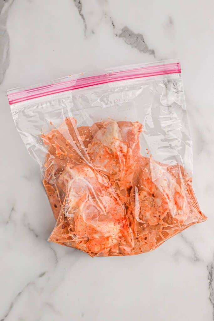 Buttermilk brined chicken for frying in a large bag.