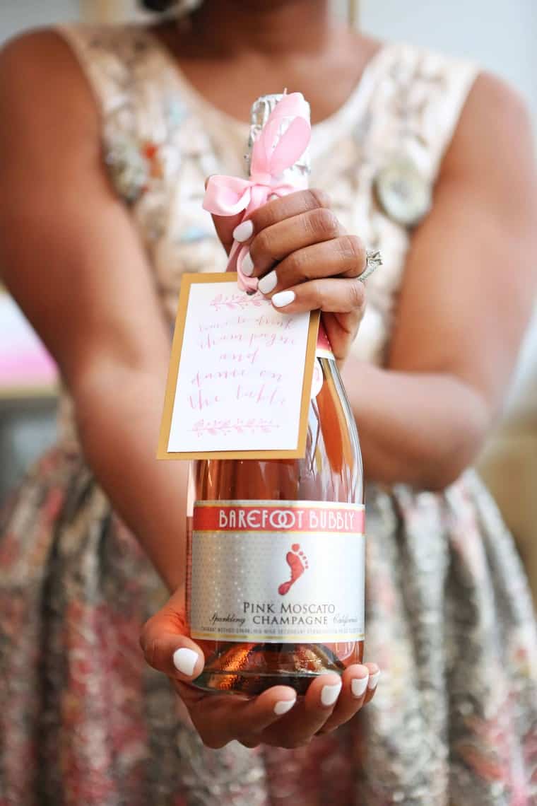 Jocelyn Delk Adams holding a bottle of Barefoot wine