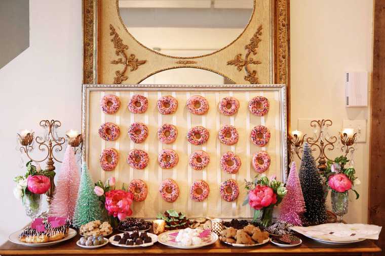 A wonderful display of pastries including a donuts hanging up on a board