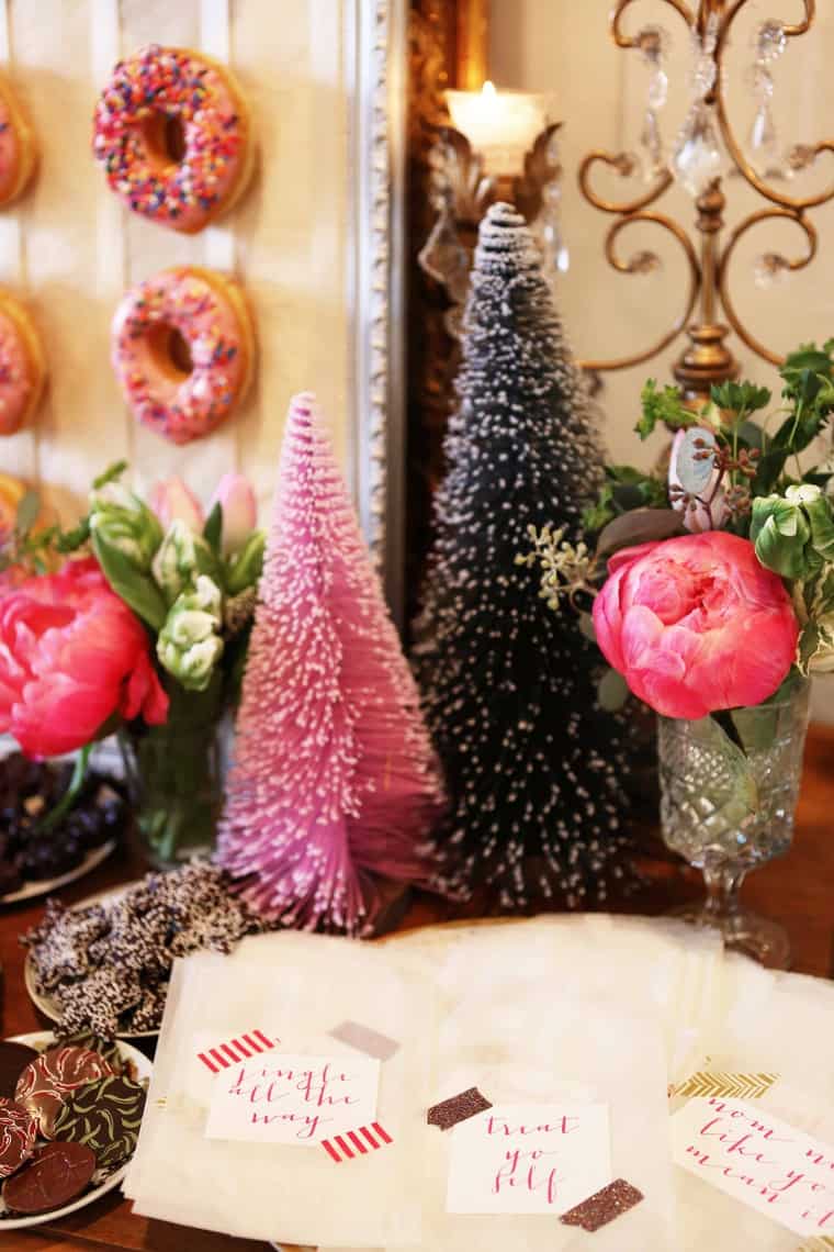 Close up of little Christmas trees, flowers and cookies at the holiday party