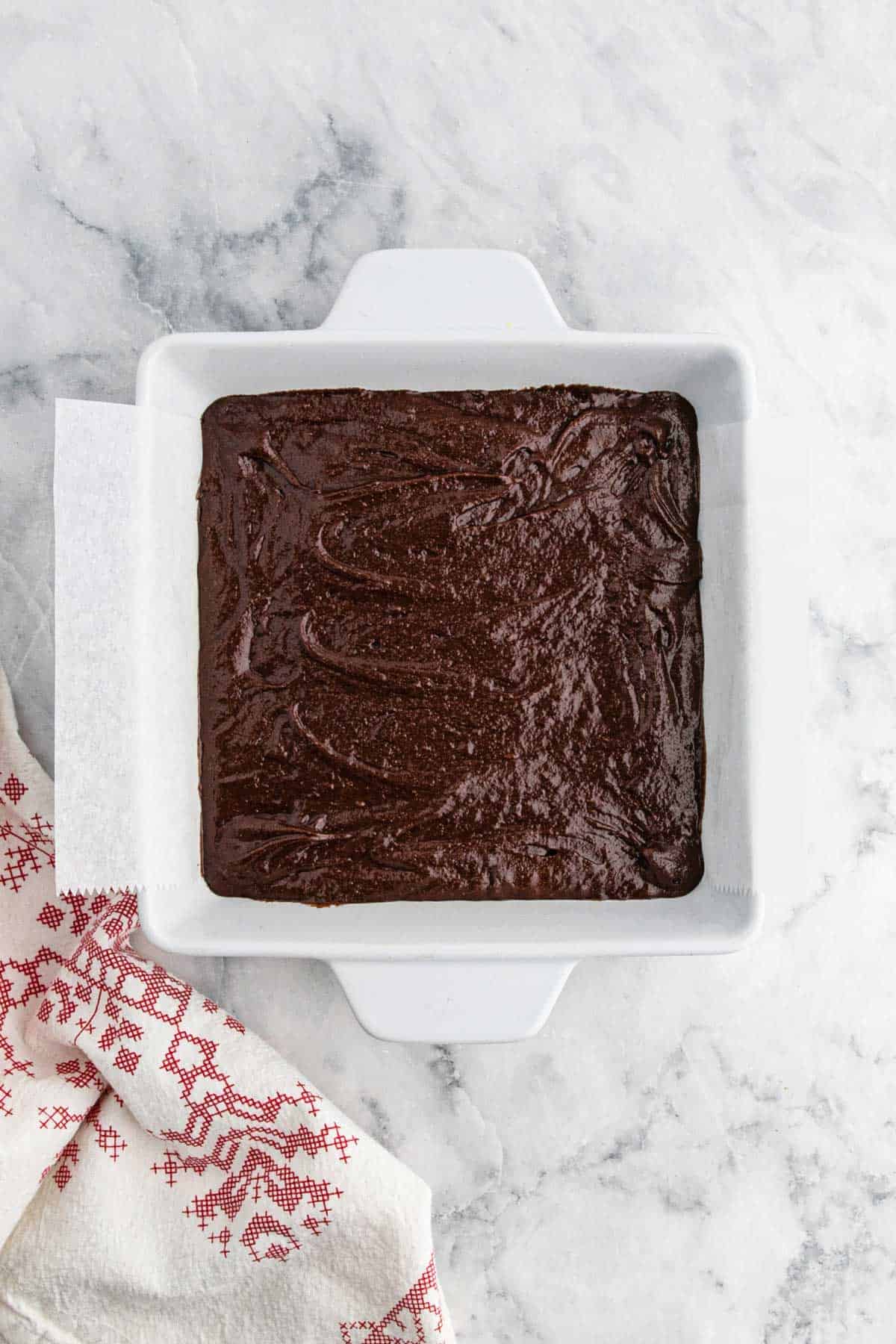Peppermint brownie batter poured into baking pan.
