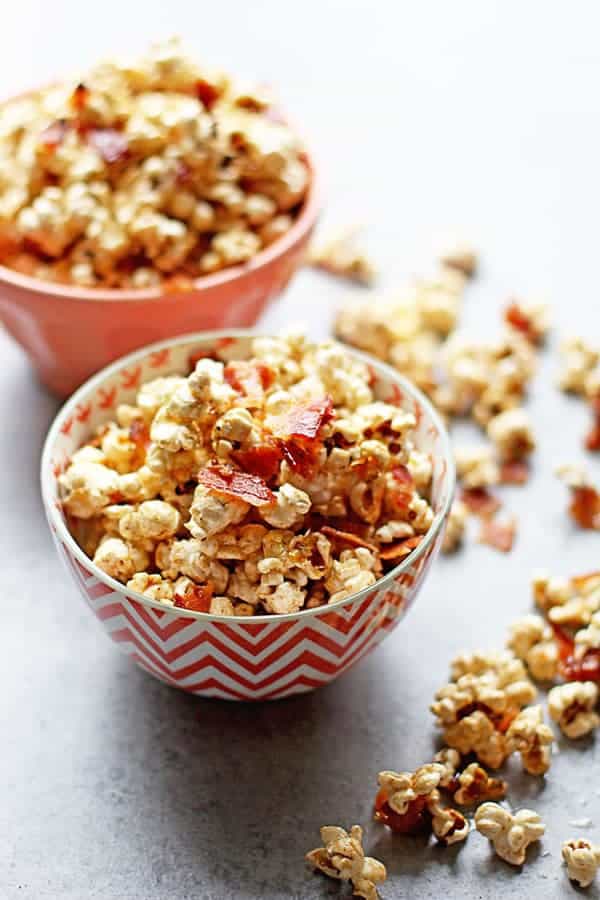 Brown Butter Maple Bacon Popcorn Recipe ready to serve spilling over in bowls for movie night