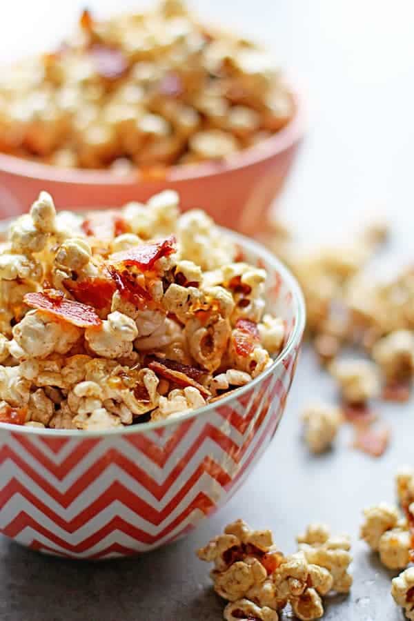 Candied maple bacon bits on top of butter popcorn ready to serve for the Super Bowl