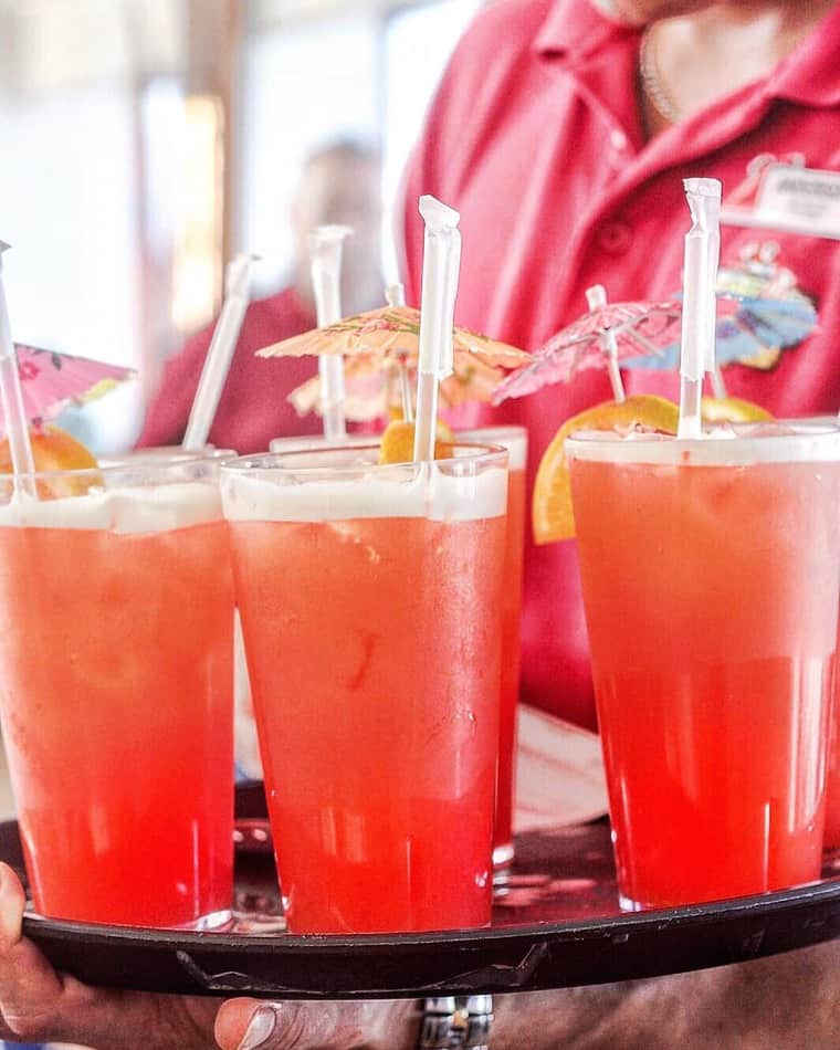 Cruise worker holding a tray full of refreshing beverages