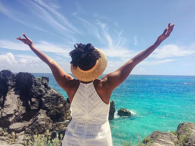 Jocelyn Delk Adams holding up her hands in the sunlight