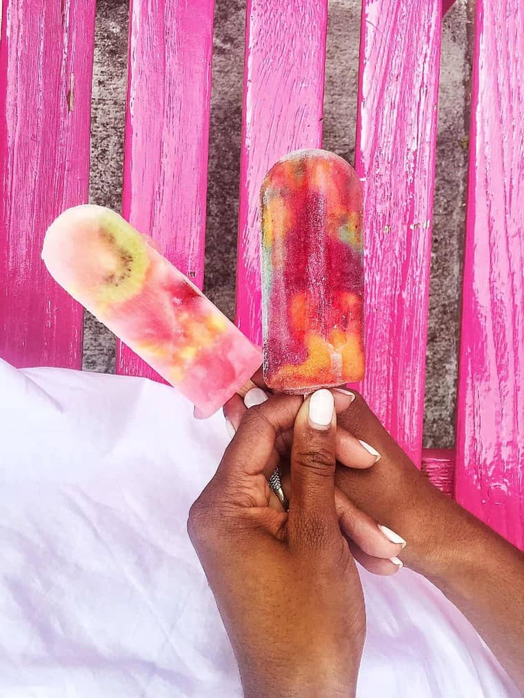 Jocelyn Delk Adams holding two fruit filled popsicles in Bermuda