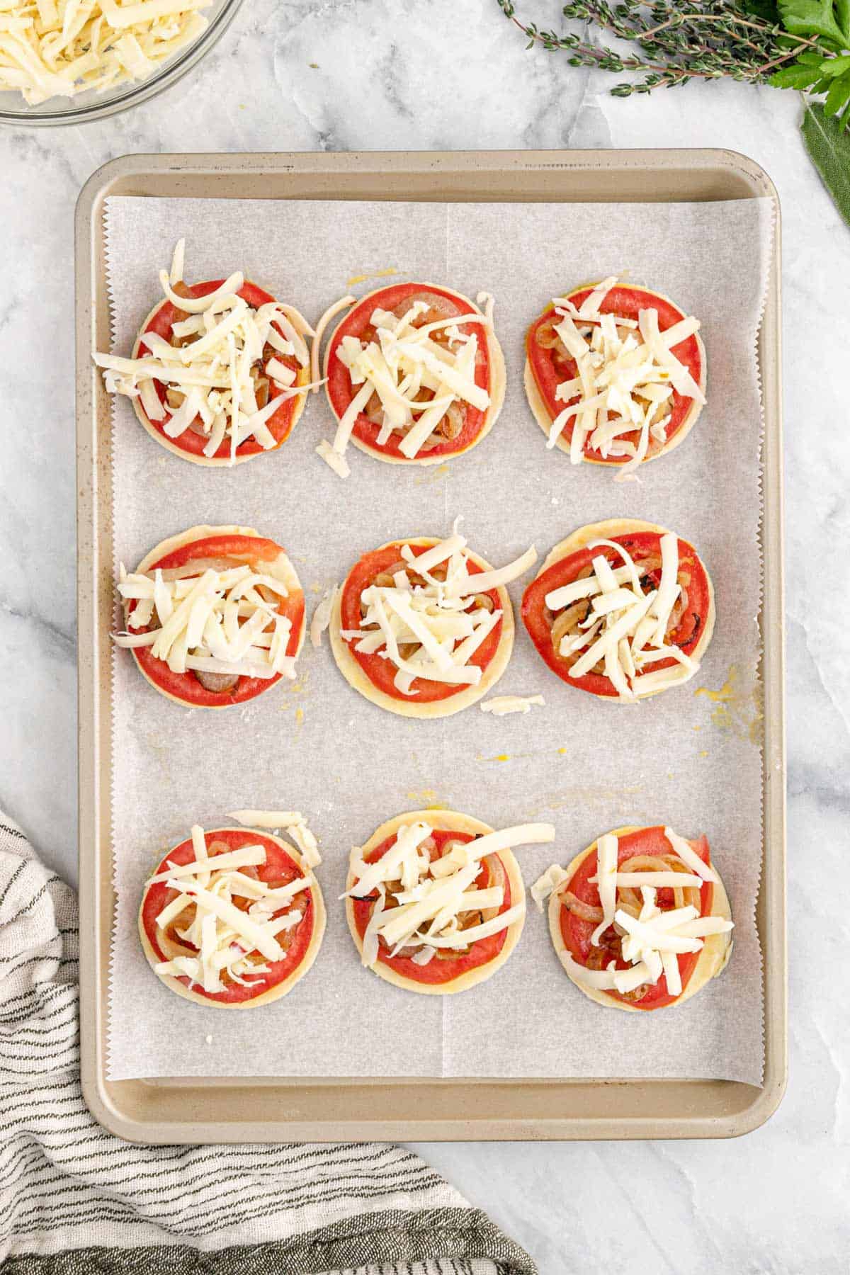 Cheese sprinkled over the tops of the tomatoes.