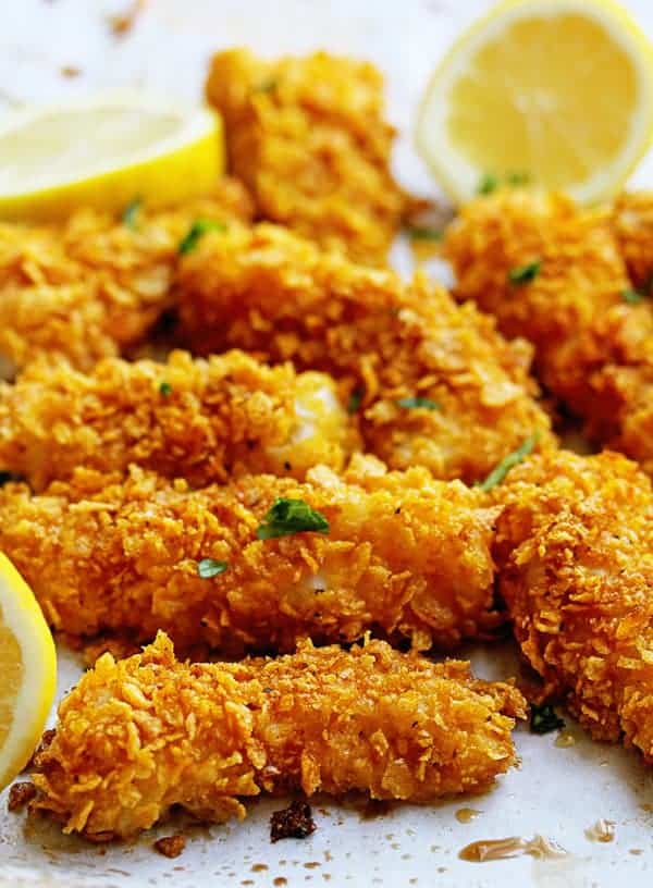 Close up of Crispy Baked Fish Sticks Recipe with lemon slices