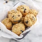 A basket of blueberry streusel muffins on the table.