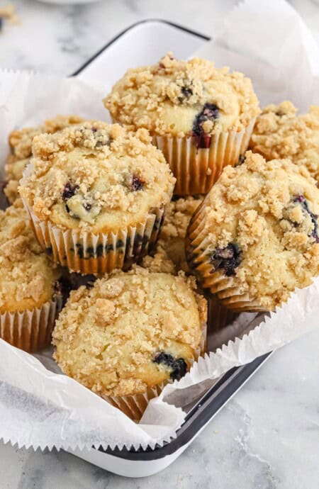 A basket of blueberry streusel muffins on the table.