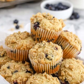 Perfect Blueberry Streusel Muffins Recipe in a pile with some in the background