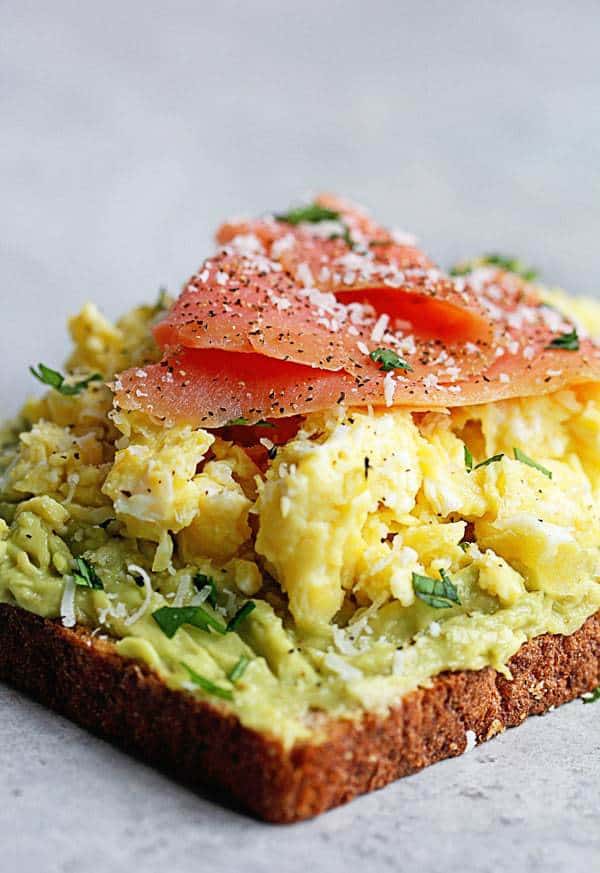 Avocado Toast Recipe topped with scrambled eggs and salmon.