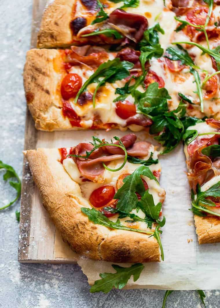 Overhead shot of Grilled Prosciutto Pizza cut into square slices