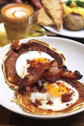 Pancakes, bacon and sunny side up eggs at HolyBelly