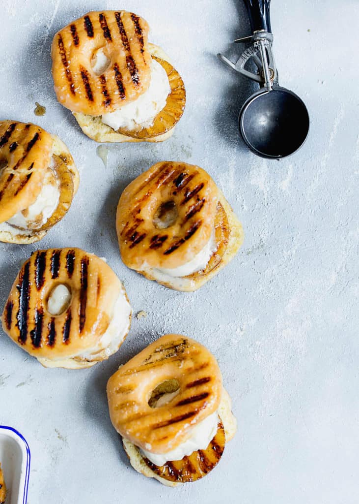 Overhead shot of Grilled Pineapples inside sliced grilled glazed donuts with vanilla ice cream