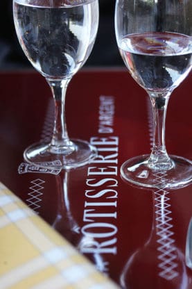 Two glasses of water on a table at La Rotisserie