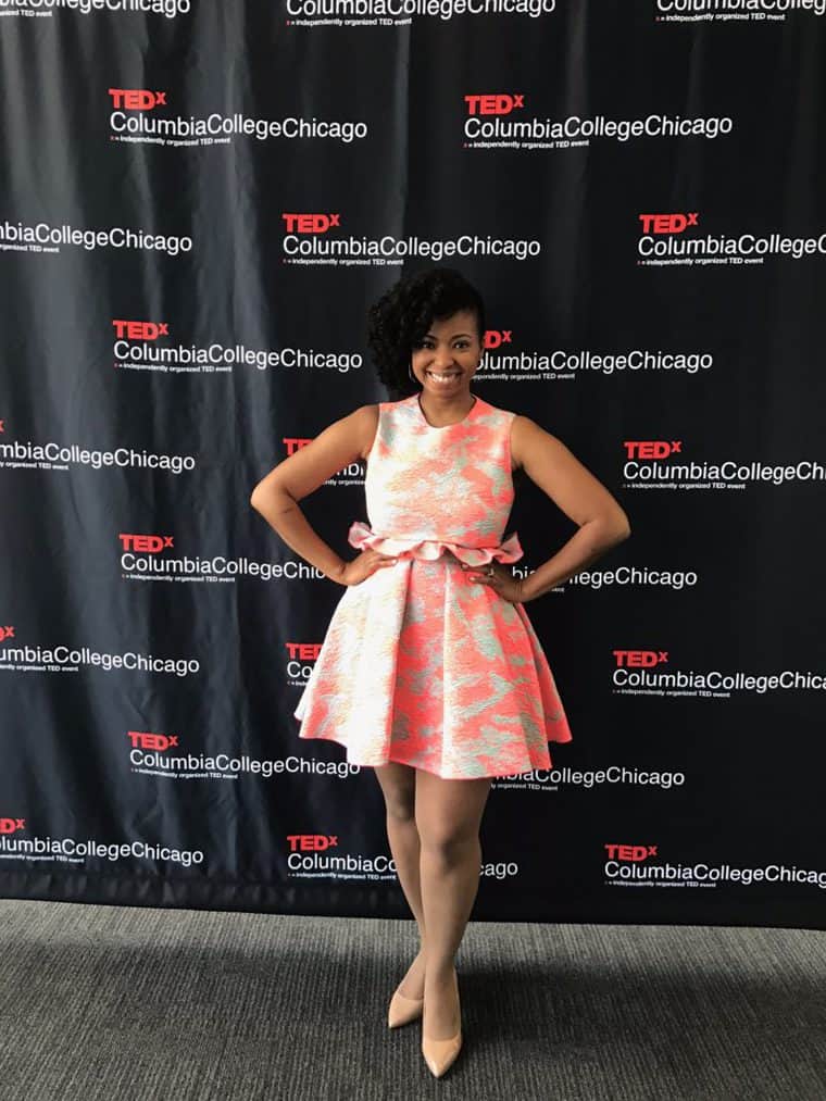 Jocelyn standing in front of a TEDX sign before her TedTalk
