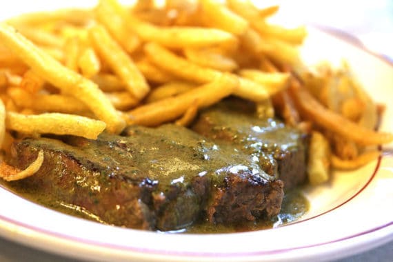 Close up of a plate with steak frites at Le Relais de L'entrecote, a famous restaurant in Paris