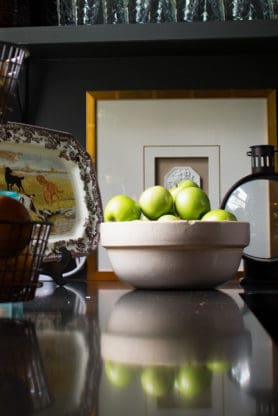 A bowl of green apples in the kitchen at The HoneyMoon House in Madison, Georgia 