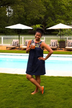 Jocelyn sipping a drink by the pool at The HoneyMoon House