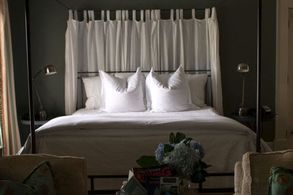 Photo of a bed in one of the rooms of the James Madison Inn in Madison, Georgia