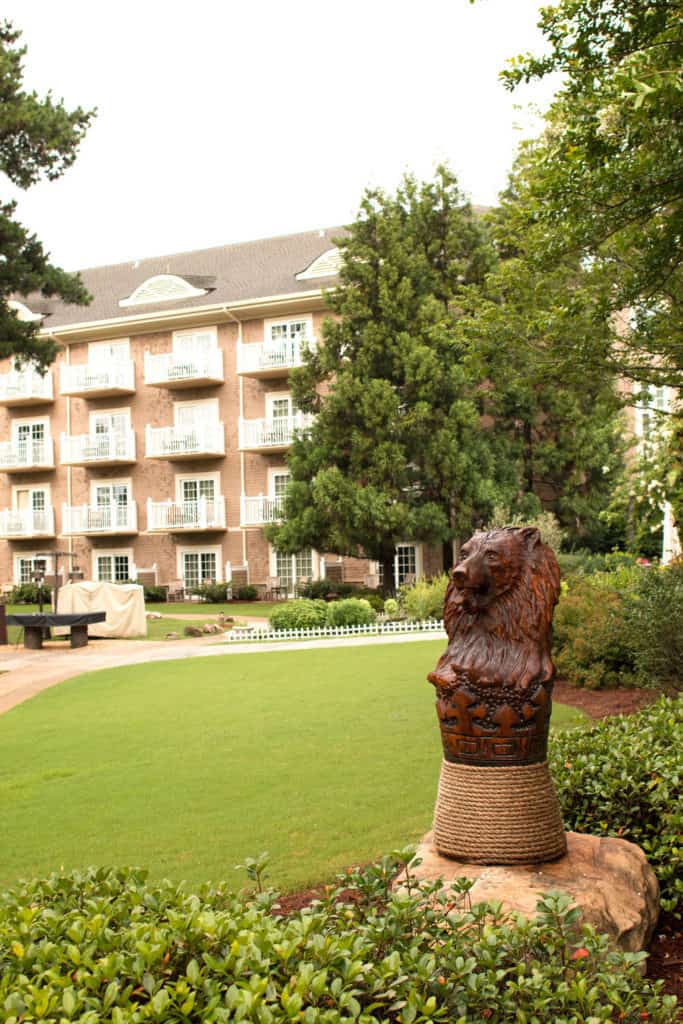 The grounds of the Ritz-Carlton hotel with a lion statute in the foreground in Georgia
